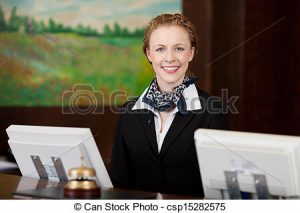 Happy woman working as a receptionist in a hotel